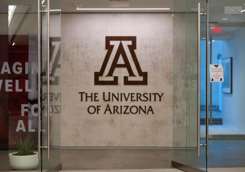 Glass doors stand open to the entrance to the University of Arizona Washington, D.C. Center for Outreach &amp; Collaboration Office.